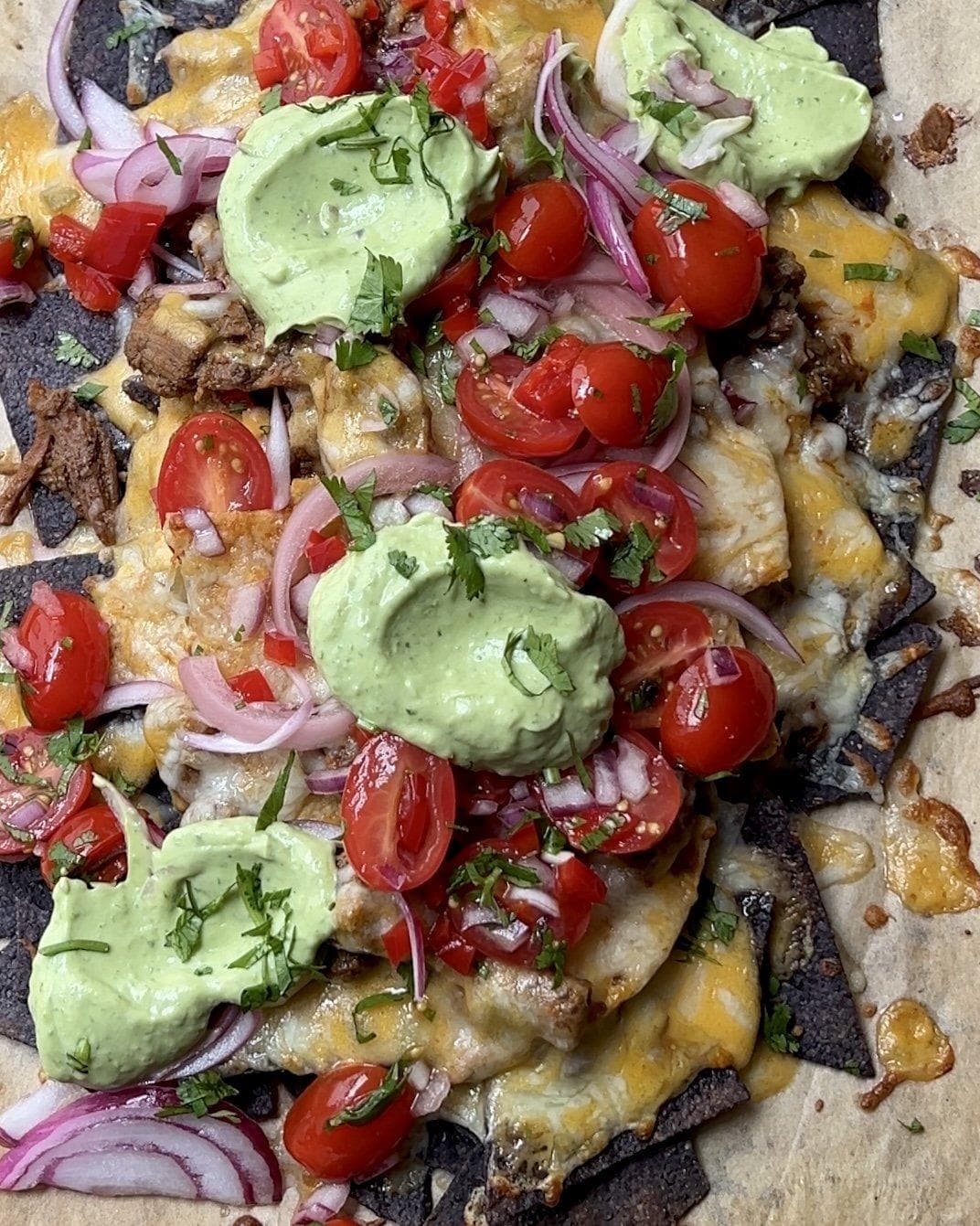 Birria Nachos with Avocado Crema and Pickled Onions